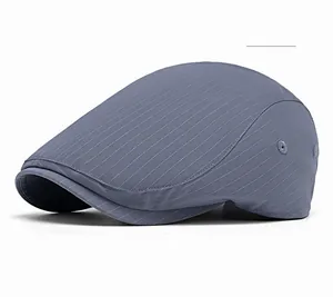 Detail of blue striped beret cap with metal eyelet and breathable textured fabric