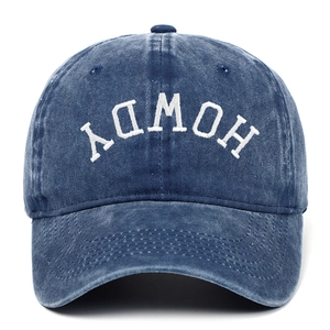 Close-up of Howdy embroidery on washed blue denim baseball cap with vintage texture