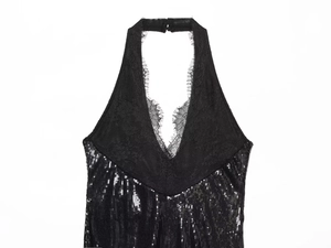 Detail of black sequined halter neck dress with delicate lace trim at the neckline