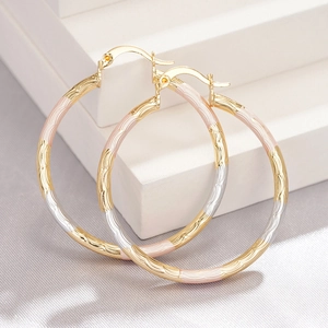 Exaggerated tricolor gold hoop earrings with wave pattern for evening wear