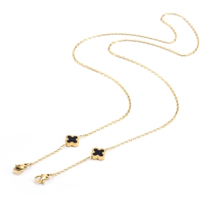 Detail of gold-tone chain featuring black clover charms and secure lobster clasps