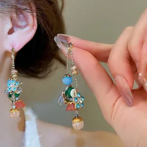 Bohemian crystal flower tassel earrings with colorful beads on a model's ear