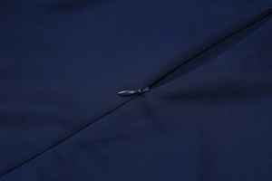 Detailed view of invisible zipper closure on a navy blue summer backless dress