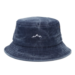Washed denim bucket hat featuring mountain peak embroidery and metal eyelets