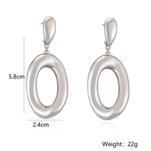 Detail of silver drop and oval earrings with dimensions 5.8cm by 2.4cm and 22g weight