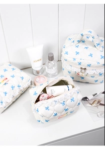 Three-piece quilted bow makeup bag set with lace trim and elegant pearl zippers