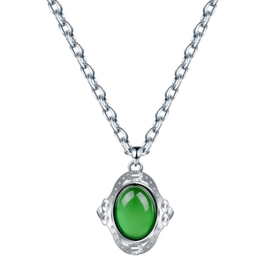 Collier vintage avec pierre verte ovale et cadre argenté en relief sur chaîne croisée