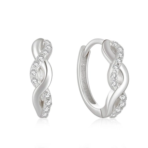 Macro shot of silver twisted hoop earrings with sparkling pave-set zircons and reflections