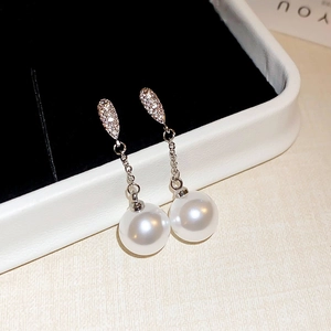 Elegant silver earrings with sparkling zircon leaves and large white hanging pearls