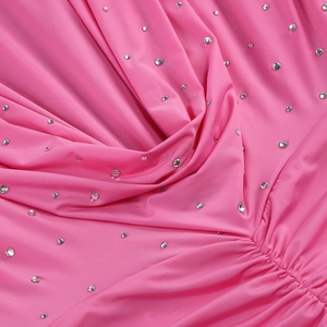 Detail of pink ruched fabric with sparkling silver rhinestones on long sleeve dress