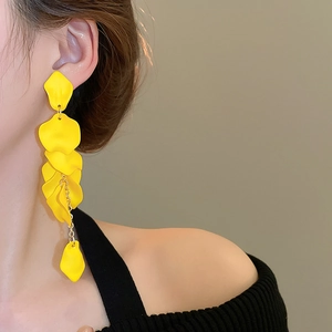 Close-up of elegant yellow petal tassel earrings worn by a model in a profile view