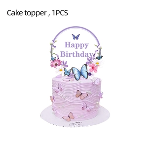 Close-up of a Happy Birthday cake topper with purple floral wreath and butterfly details