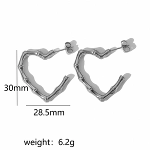 Detail of silver heart earrings featuring bamboo texture and 30mm dimensions