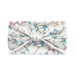 Macro detail of Christmas light bulb pattern on soft fabric knotted headband
