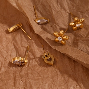 Detailed macro view of 18K gold plated stainless steel stud earrings with cubic zirconia