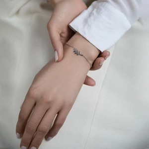 Minimalist 925 sterling silver leaf charm bracelet for women on white background