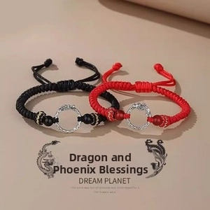 Detailed view of woven dragon-themed couple bracelets with metallic buckles and beads