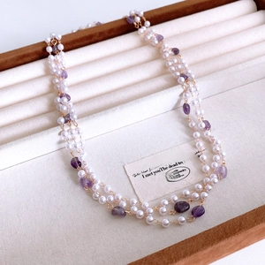 Detail of French vintage layered necklace with white pearls and amethyst stones on tray