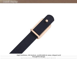 Detail of light gold alloy buckle on black PU leather belt with multi plating process