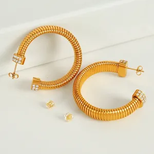 Golden spiral hoop earrings with rhinestone accents and silicone backings
