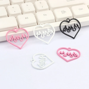 Detail shot of heart-shaped flame charms in pink white and black alloy finishes