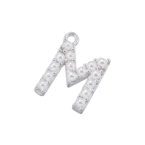 Detailed view of capital letter M pendant with 18K gold plating and white pearls