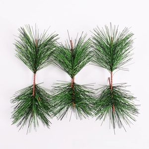Detail of green artificial pine branches with white snow tips for DIY Christmas wreaths
