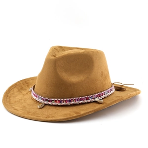 Detail of tan suede cowboy hat featuring colorful woven band and seashell accents