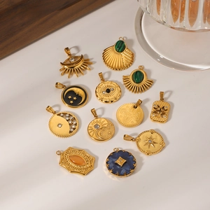 Set of twelve gold stainless steel pendants with celestial moon and star designs