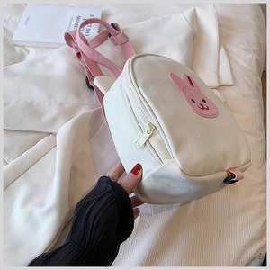 Detail shot of canvas cross-body bag with cute 3D pink bunny embroidery and pink strap