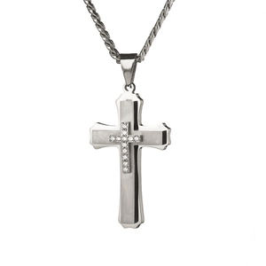 Macro shot of silver multilayer cross pendant with cubic zirconia and rope chain detail