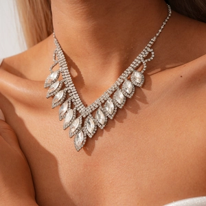Close-up of a silver tassel necklace with rhinestones on a model for evening wear