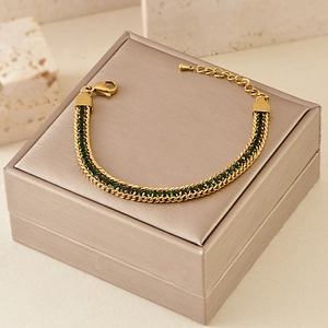 Detailed view of bohemian gold bracelet with green zircons and adjustable lobster clasp