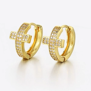 Close-up of gold-plated cross earrings with micro-paved white cubic zirconia stones