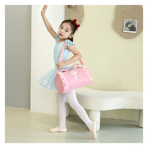 Detailed view of pink ballet bag with lace trim and dancer silhouette carried by a child