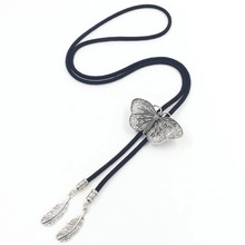 Detailed view of butterfly bolo tie with black braided cord and feather metal charms