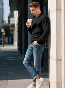 Close-up of premium black waffle knit texture on a men's long-sleeve polo sweater