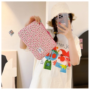 Pink floral laptop sleeve held by a person showing its real size and soft fabric texture