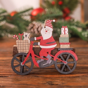 Painted wooden Christmas ornament featuring Santa riding a bicycle with gifts and bear