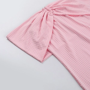 Detail of pink fabric with dense silver rhinestones and elegant ruched texture