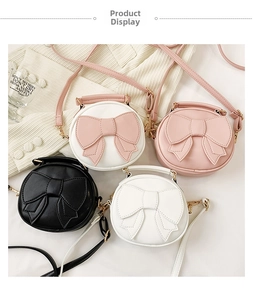 Flat lay of small round crossbody bags with big bow details in four pastel colors