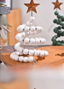 Detail of the back view of a white wooden bead spiral Christmas tree with a rusty metal star