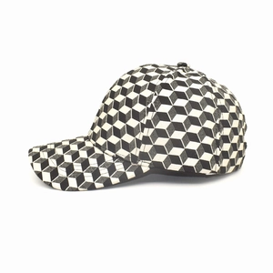 Side profile of checkerboard baseball cap with 3D cubic geometric patterns