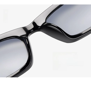 Macro shot of high-gloss black cat eye sunglasses featuring comfortable integrated nose pads