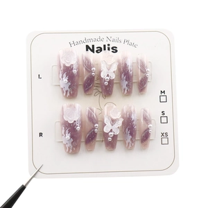 Handmade purple gradient press-on nails with 3D butterflies, pearls, and roses on a card