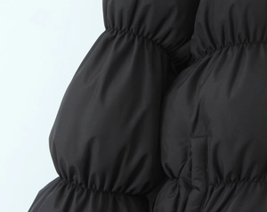Close-up of quilted black puffer jacket showing smooth fabric texture and tight stitching