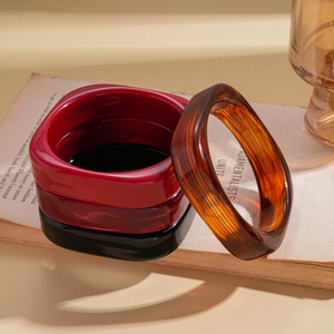 Set of four geometric resin square bangles in red, black, and amber marble textures