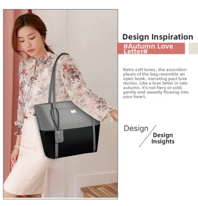 Detailed view of large grey and black patchwork tote bag worn by a model in daily scene