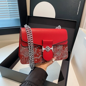 Elegant red chain crossbody bag with intricate floral embroidery design and silver buckle