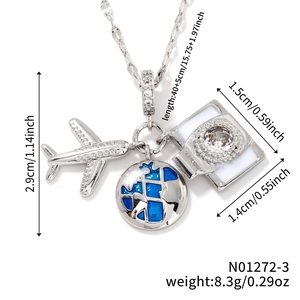 Detailed view of travel-themed necklace with airplane, blue globe and camera charms